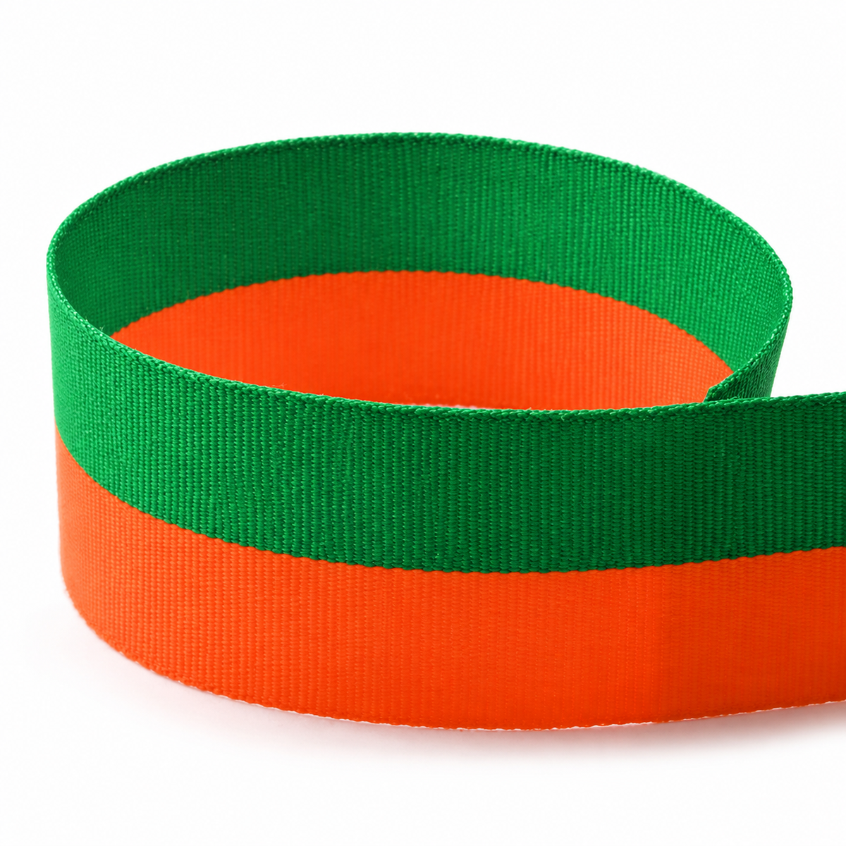 Emerald green and orange Bi-Stripe grosgrain ribbon shown in a loose loop.